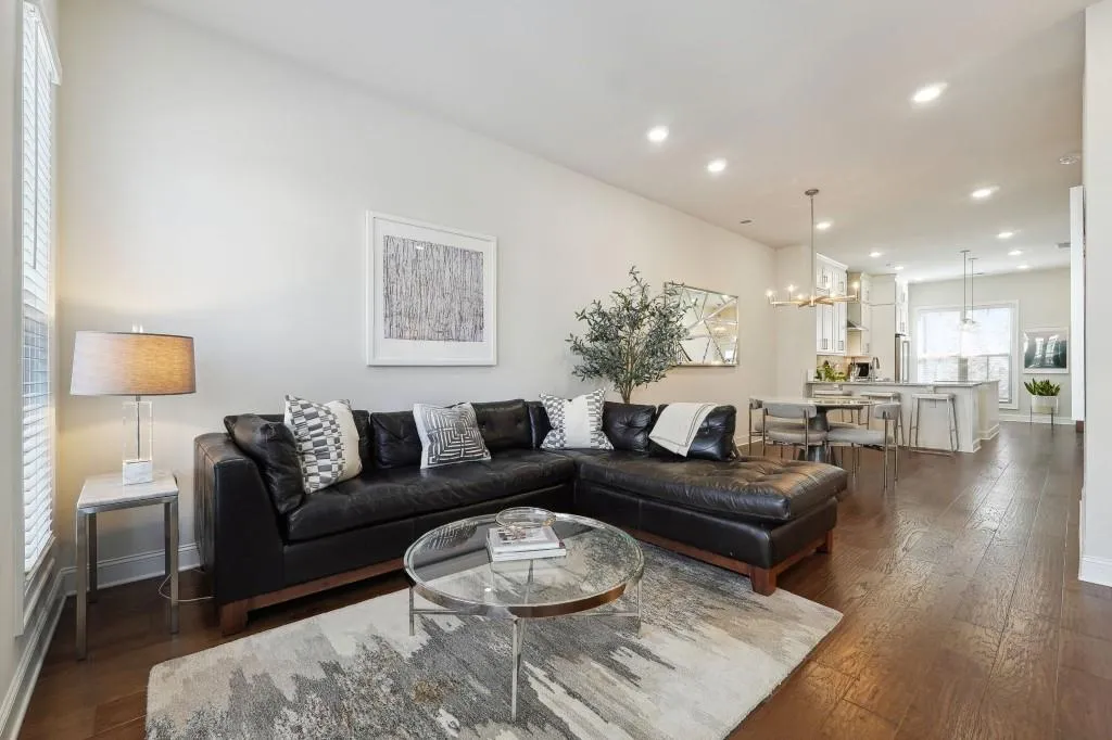 Living room featuring an inviting chandelier and dark wood-type flooring