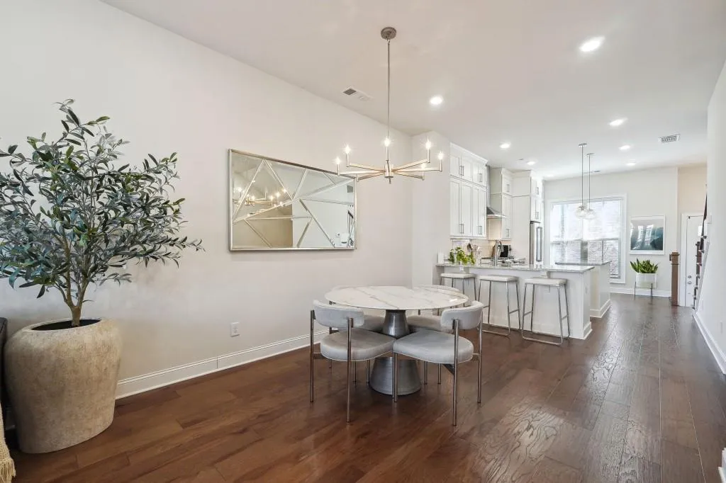 Dining room with dark hardwood / wood-style floors and a notable chandelier