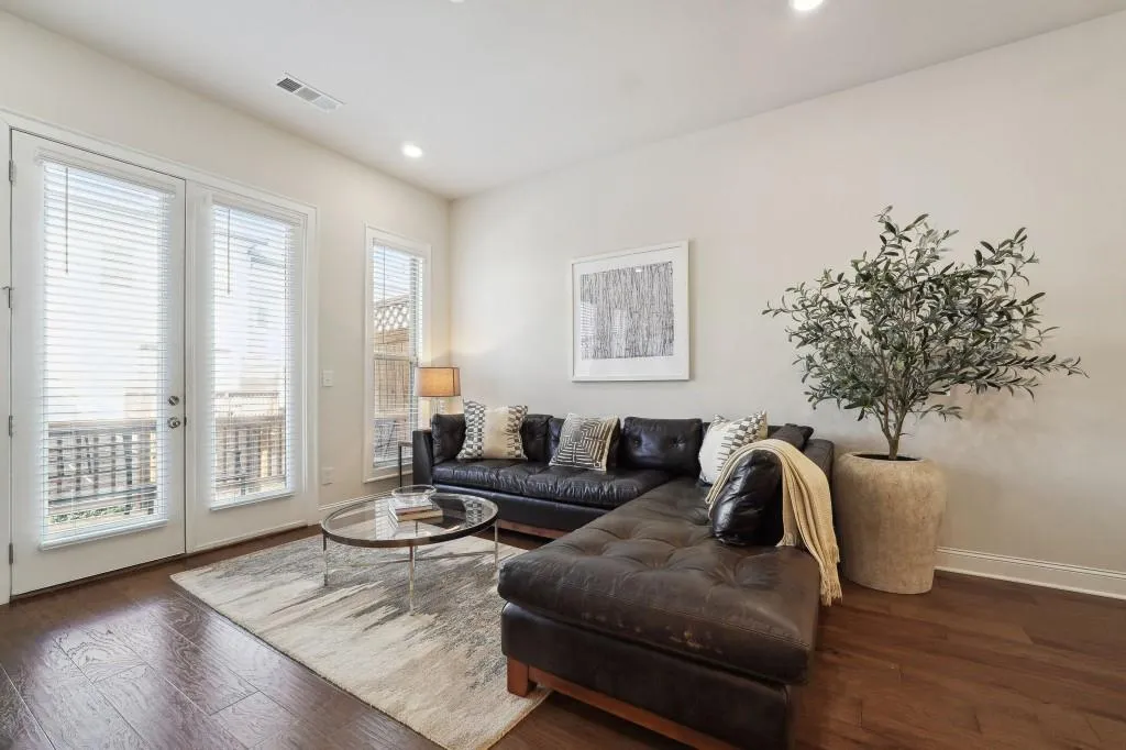 Living room with french doors and dark wood-type flooring