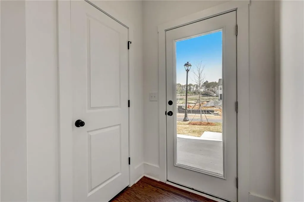 Glass French door leads to re rear patio. Photo example only.