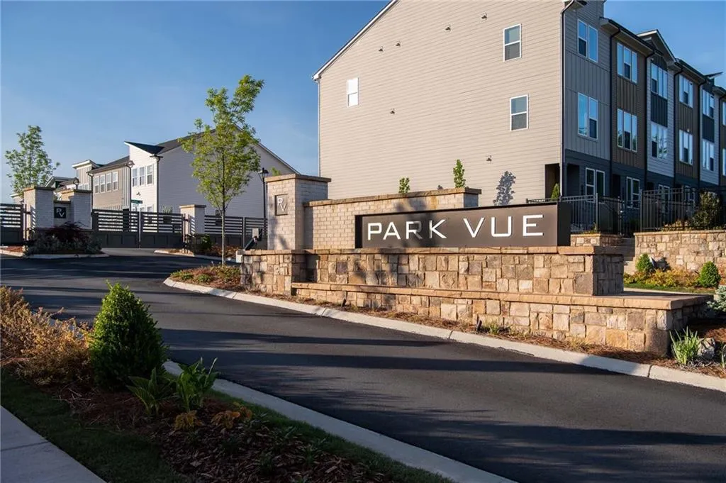 Community / neighborhood sign featuring a residential view