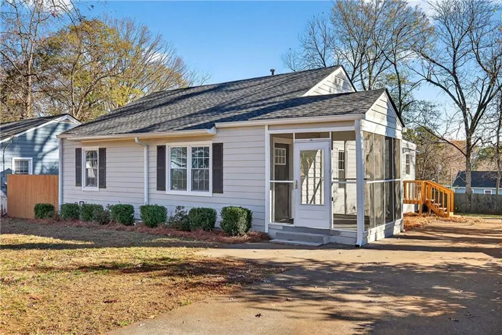 View of front of home with a shingled roof