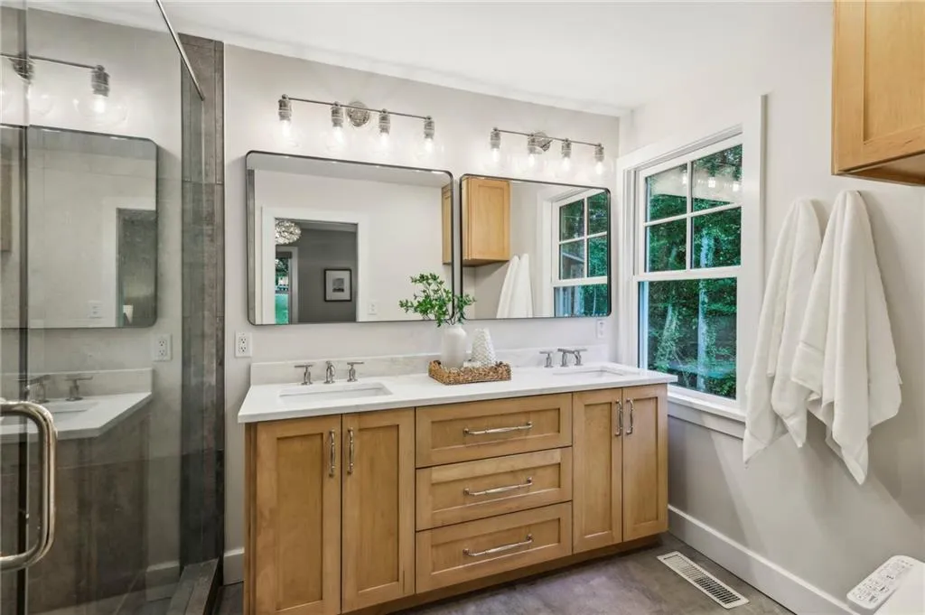 Primary bathroom with double sinks and custom cabinetry