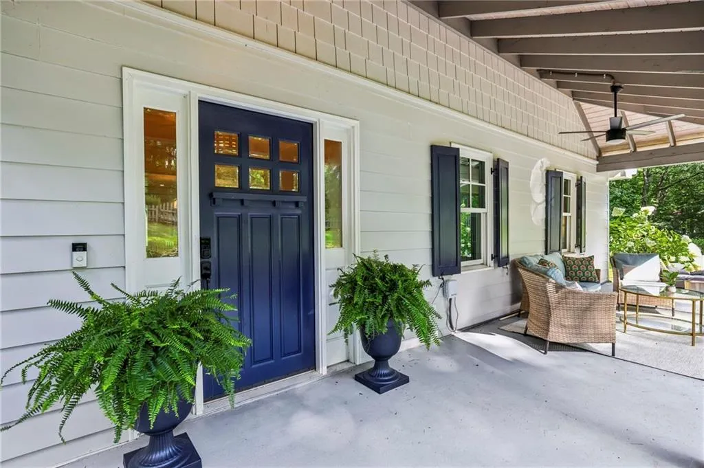 Covered front porch with ample sitting area for enjoying the green views