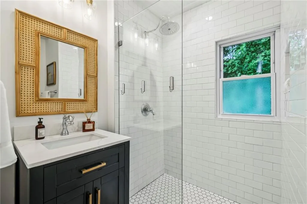Main level full bath with frameless glass shower