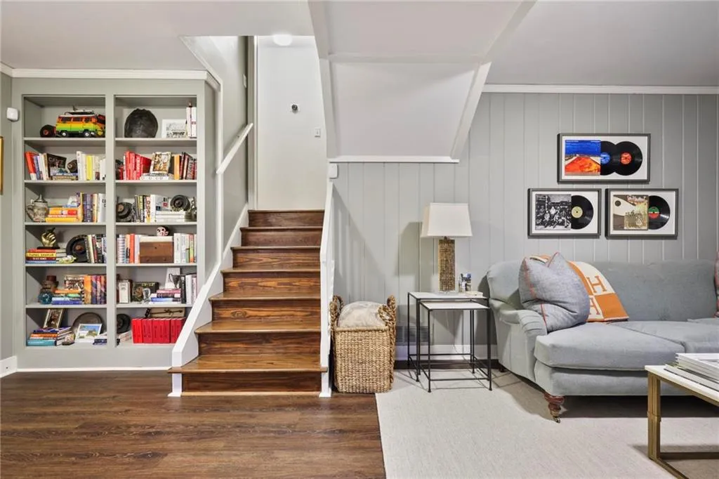 Stairs featuring crown molding and wood finished floors
