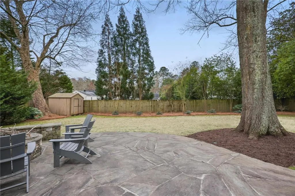 View of patio / terrace with a storage shed, an outdoor structure, and fence
