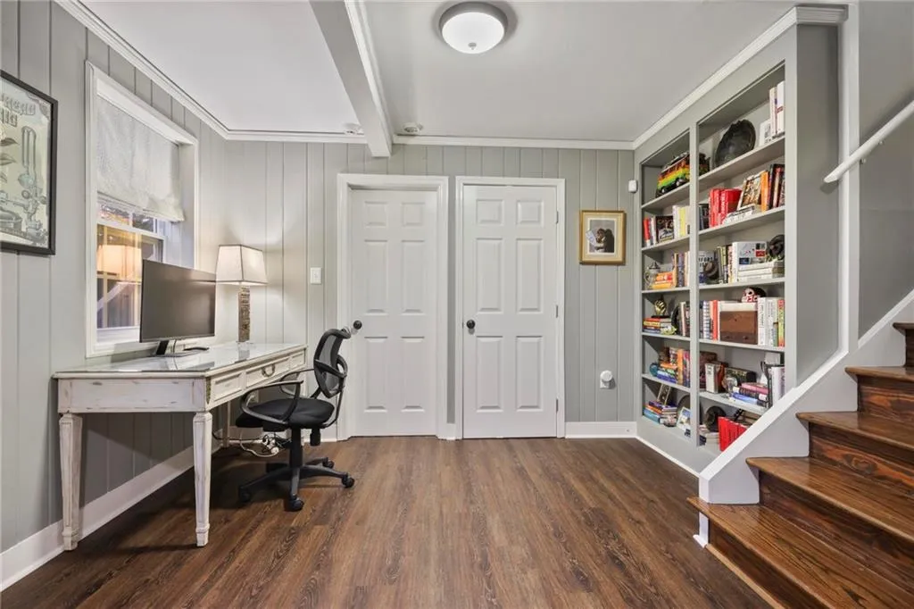 Office featuring beamed ceiling, baseboards, and wood finished floors