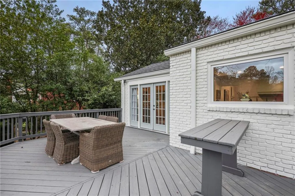 Wooden terrace featuring french doors and outdoor dining area
