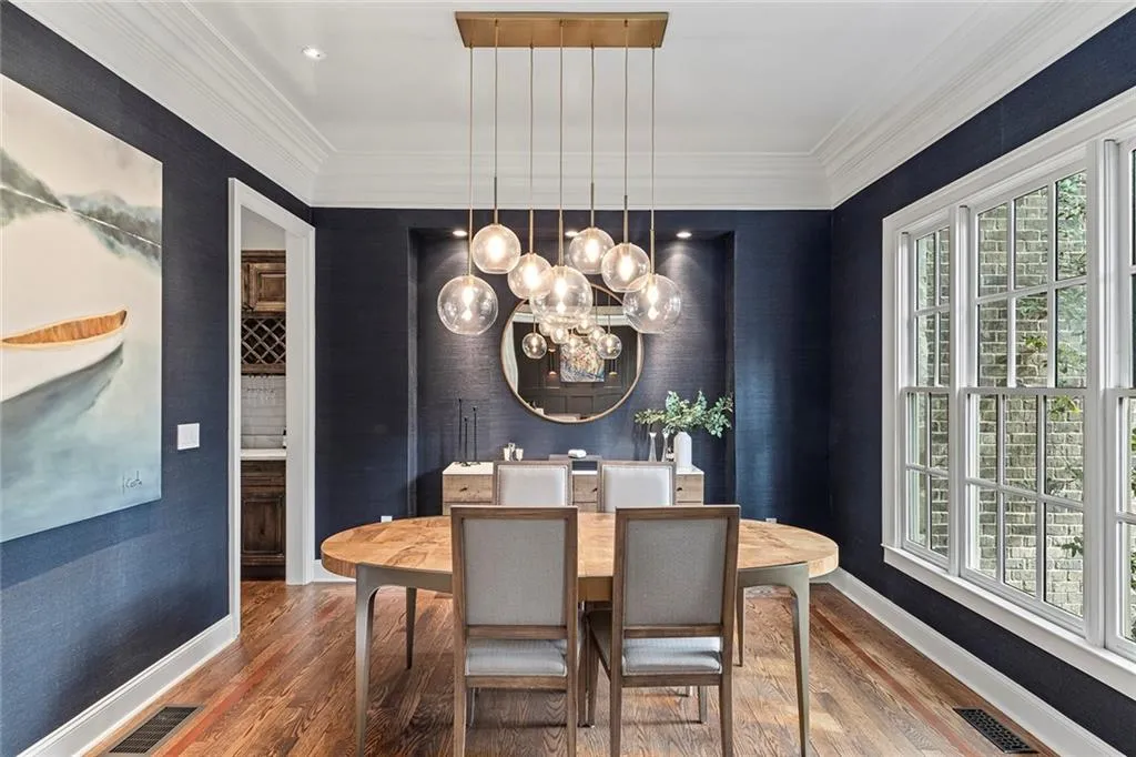 Dining space featuring crown molding, wood finished floors, and a chandelier