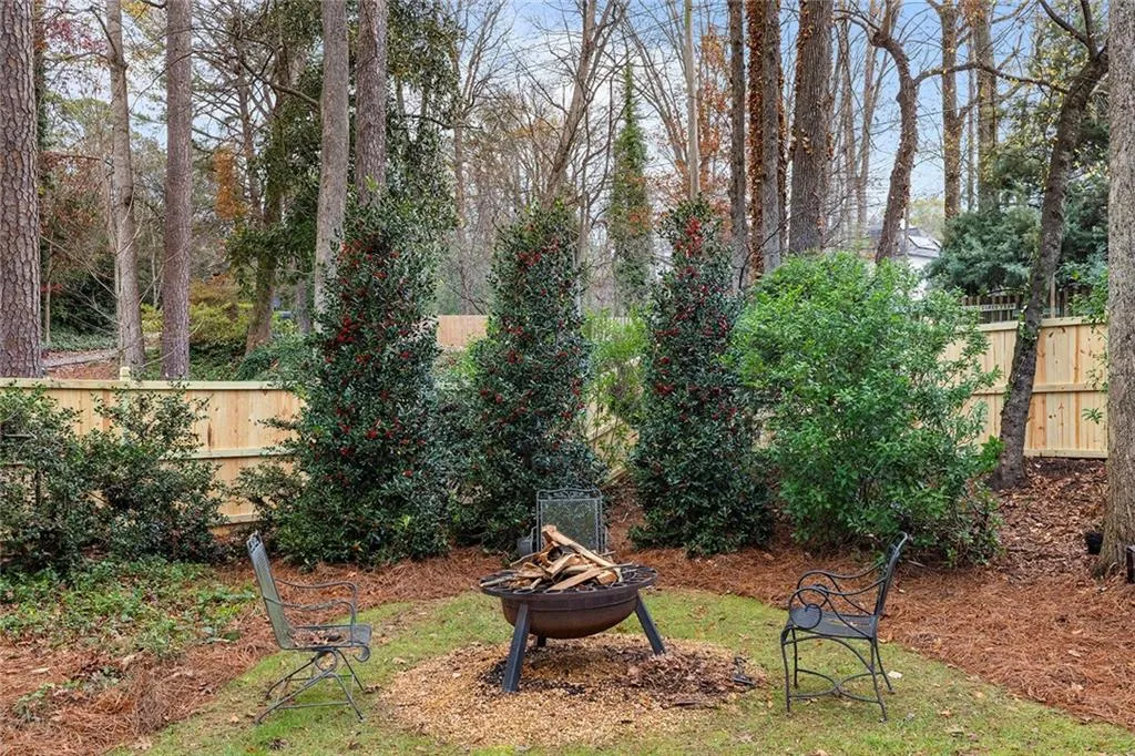 Fenced backyard featuring an outdoor fire pit