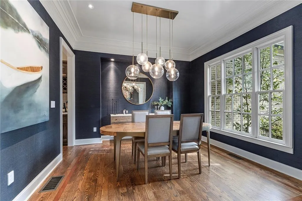 Dining room with crown molding, a chandelier, and wood finished floors