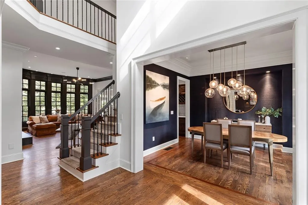 Dining room with a chandelier, ornamental molding, dark wood-style flooring, recessed lighting, and a high ceiling