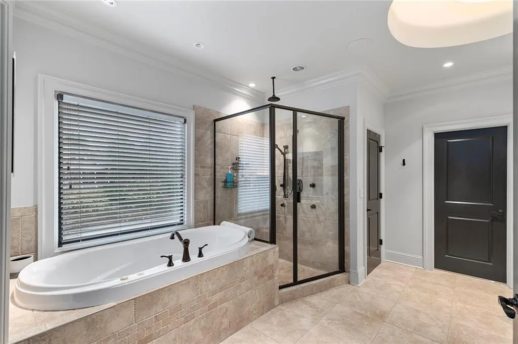 Bathroom with a garden tub, ornamental molding, a shower stall, light tile patterned flooring, and recessed lighting