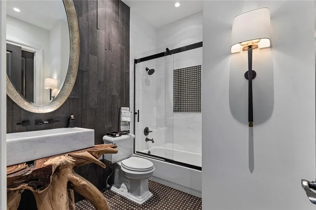 Bathroom featuring enclosed tub / shower combo and vanity