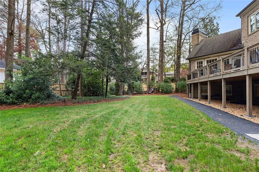 View of green lawn with a deck
