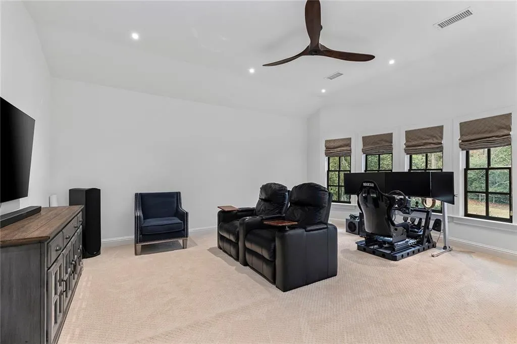Living room featuring a desk, lofted ceiling, recessed lighting, light carpet, and a ceiling fan