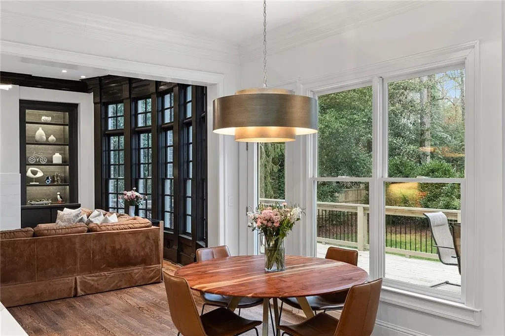 Dining area featuring wood finished floors, crown molding, and built in shelves