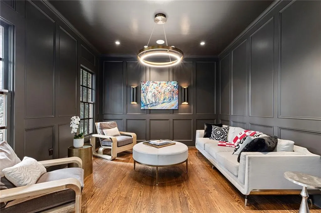 Sitting room featuring a decorative wall, wood finished floors, recessed lighting, and ornamental molding
