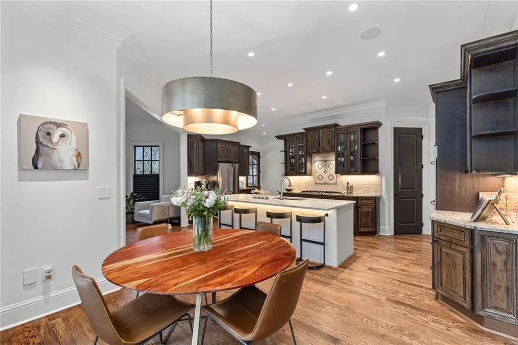 Dining room with light wood-type flooring, crown molding, and recessed lighting