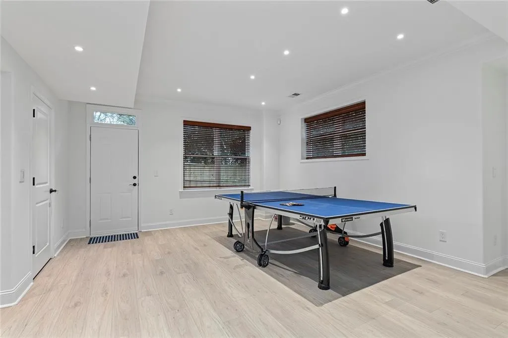 Game room with light wood-type flooring, recessed lighting, and crown molding
