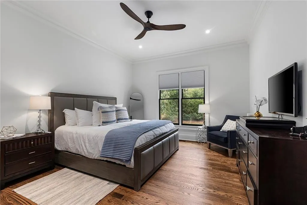 Bedroom featuring crown molding, wood finished floors, ceiling fan, and recessed lighting