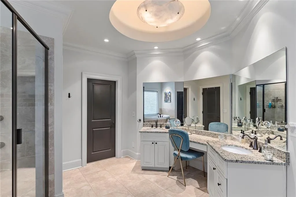 Full bath featuring a shower stall, ornamental molding, double vanity, light tile patterned flooring, and recessed lighting
