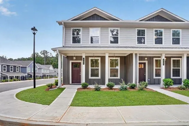 Two-story townhome featuring a light gray siding exterior with dark gray accents