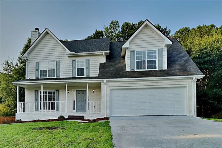 White brick and siding exterior with dark shingle roof