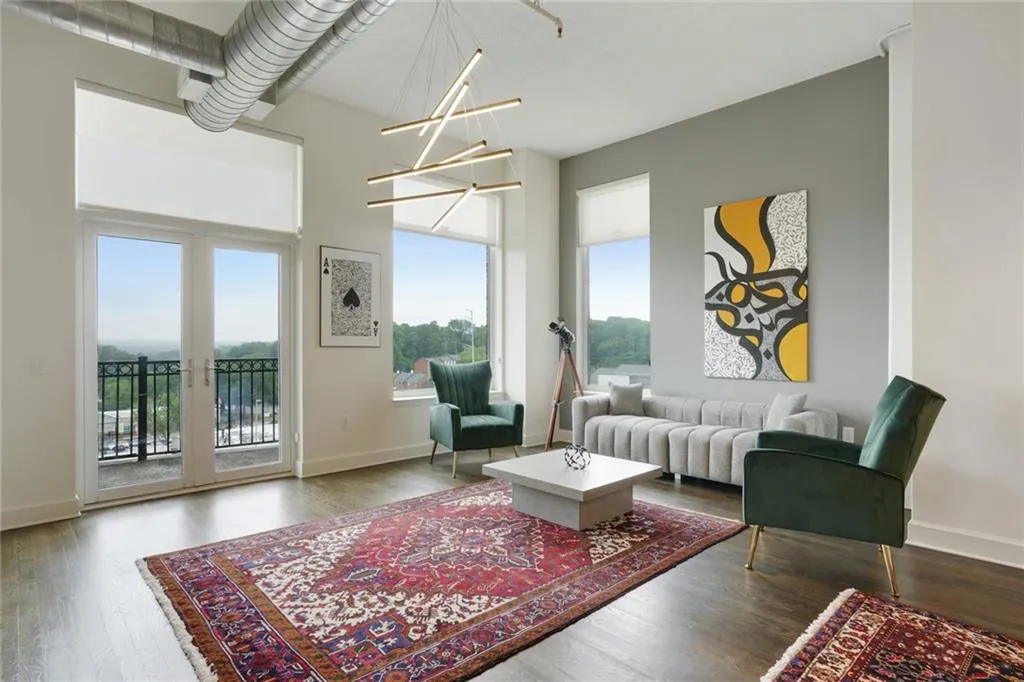 Living area featuring dark wood-style floors and a chandelier