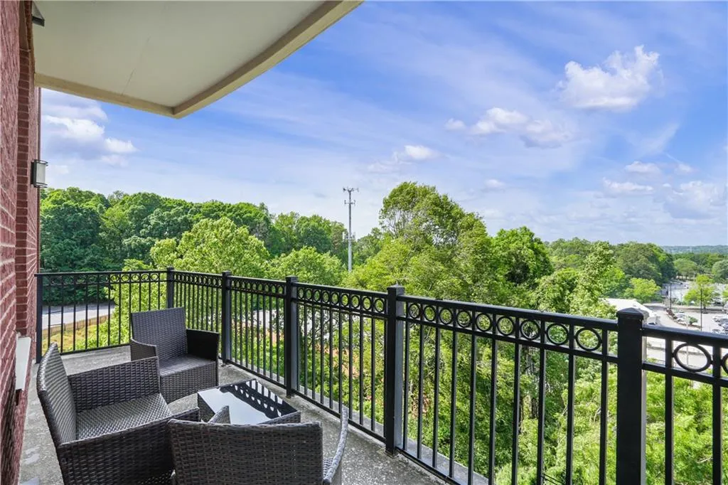 Balcony with view of wooded area