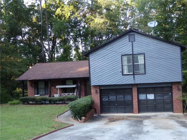 Brick and siding exterior with a shingle roof