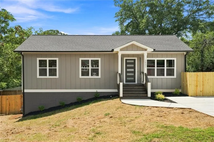 Exterior featuring vertical siding and a dark gray foundation
