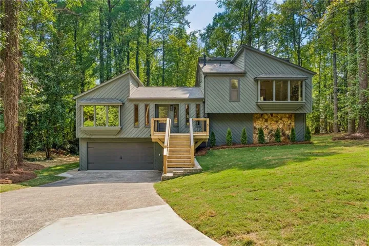 Wooded lot with a sloped lawn