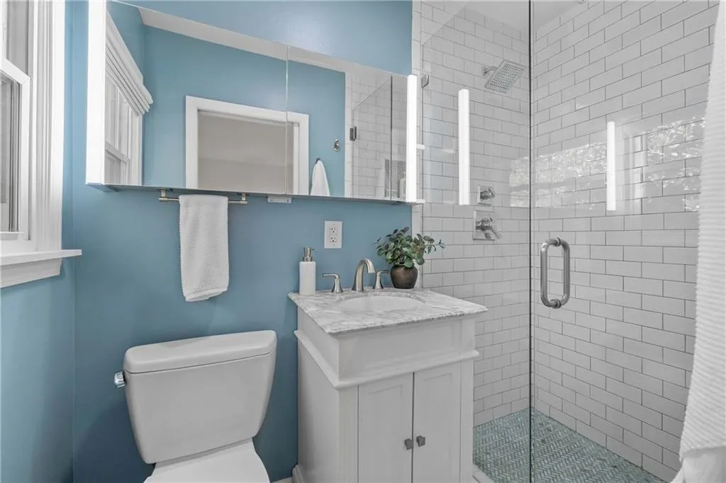 Renovated Ensuite Bathroom with marble tile floor and shower