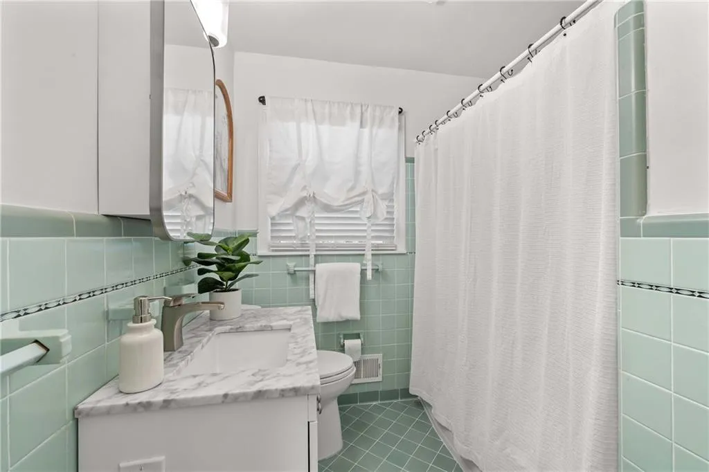 Secondary bathroom with linen closet