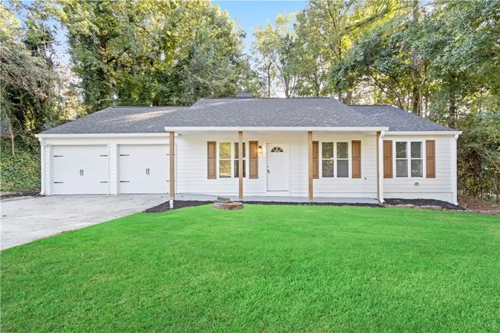 White siding exterior with a dark shingle roof