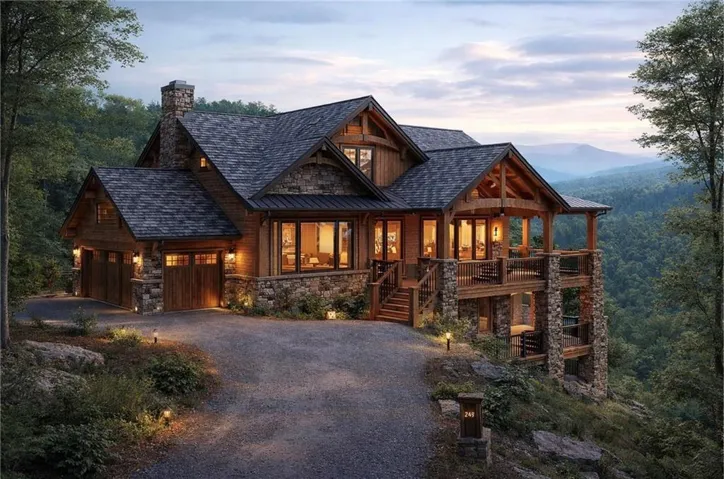 Wood-clad mountain residence featuring a stone foundation, multiple balconies, a covered porch with exposed beams, and an attached two-car garage