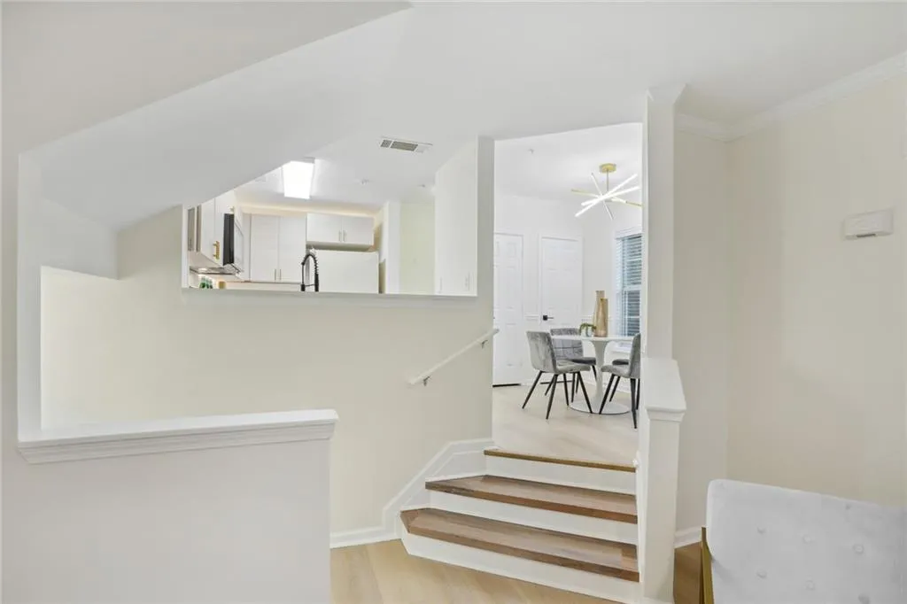 Stairway featuring light hardwood / wood-style flooring