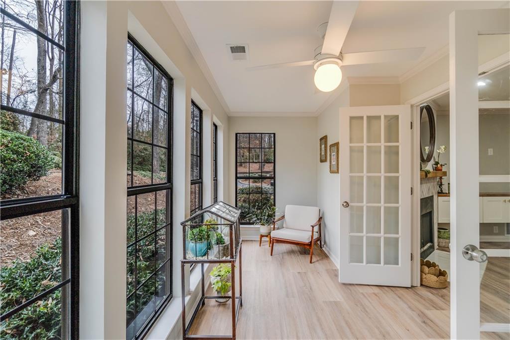 Sunroom / solarium featuring french doors and ceiling fan
