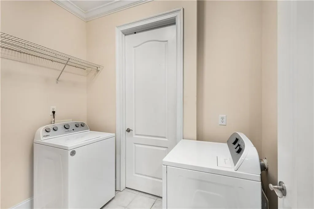 The laundry room is located on the kitchen hallway.  The washer and dryer are included in the sale.  The closed door opens to the mechanical room where the water heater and furnace are located and it also has valuable storage space.