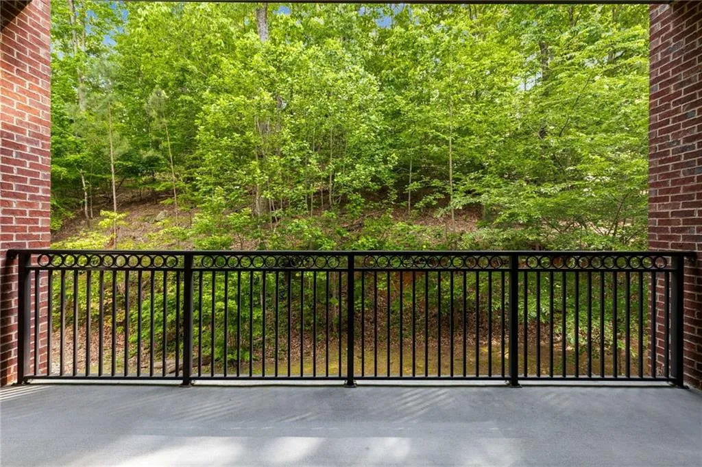 The large covered balcony is a great place to find peaceful solitude or to enjoy a gathering with family and friends regardless of the weather.  The view is of the woods of Vinings Mountain.  This is a forever view which is totally private and will never be developed,