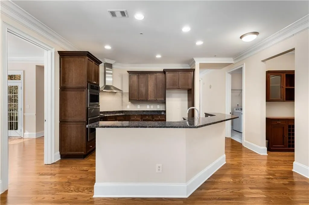This Kitchen view includes the Dining room on the left and Butler's Pantry and Laundry Room on the right.