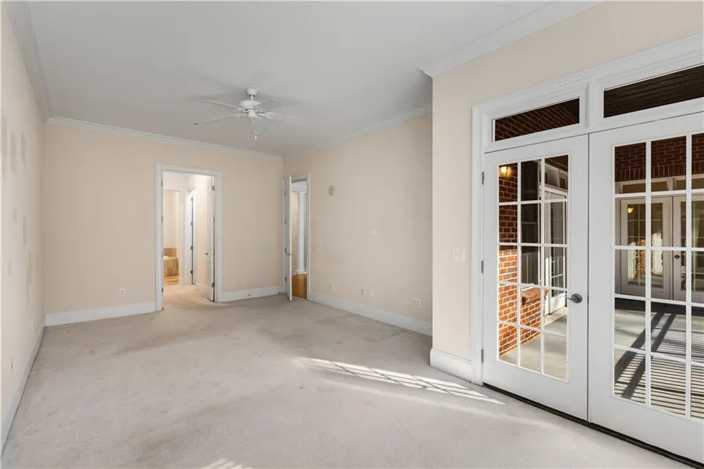 This view is from the large Sitting Area which has glass French doors for access to the Private Covered Balcony.  The primary Suite occupies the entire right side of the condominium.