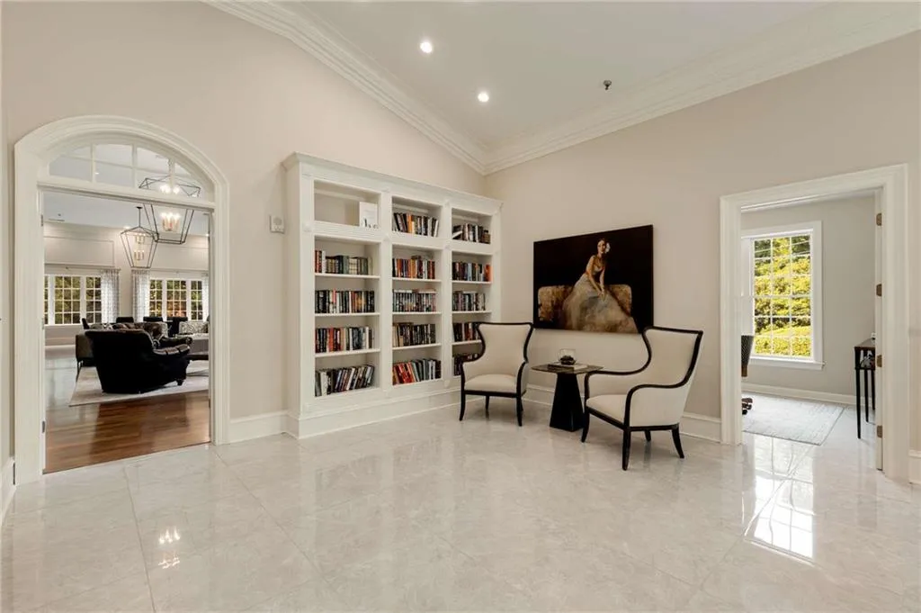 The Library is located on the upper level of the entry lobby.  You can either take a book or leave a book. The Library is outside of the Club Room which is the view through the open French doors on the left.  The door to the right is a game room or meeting room.