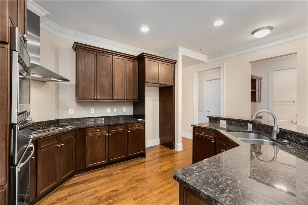 This view of the kitchen shows the location for your refrigerator up to 36 inches wide.  The door to the Laundry Room is open in the background.  The opening to the right of the Laundry Room is the Butler's Pantry.
