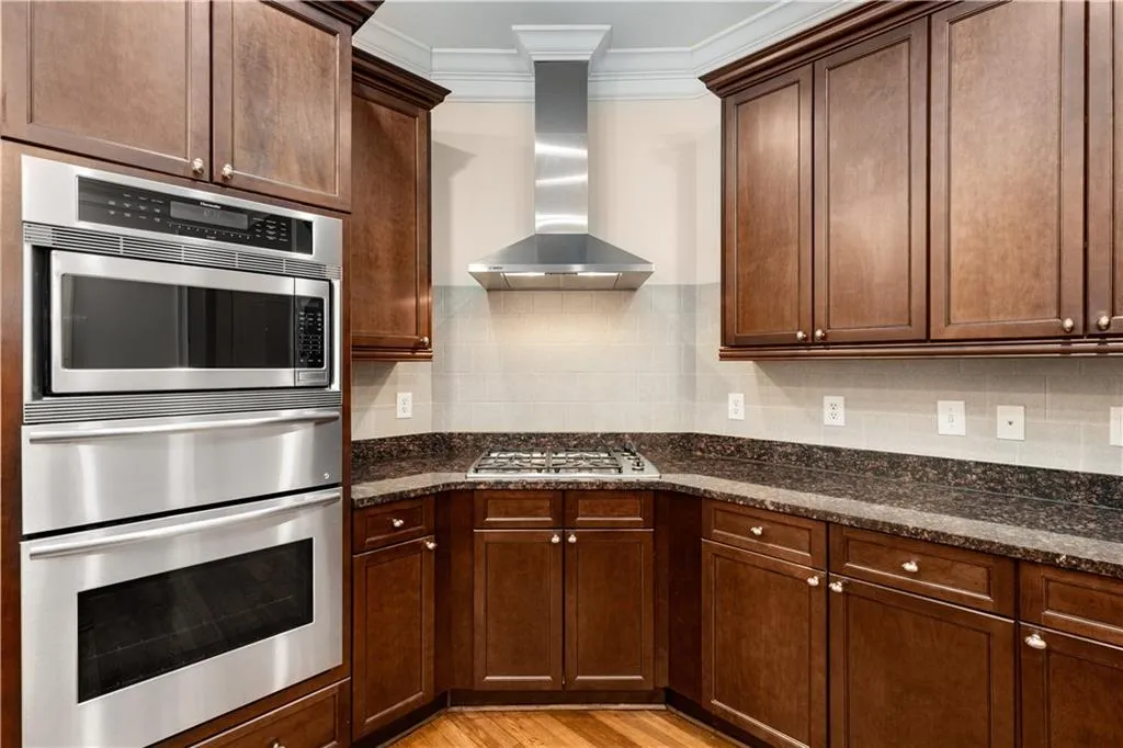 The kitchen features a Thermador cooking system with a microwave, warming drawer and convection oven.  It also has a Bosch cooktop with 4 gas burners and a wall mounted chimney vent hood which exhausts cooking odors to the outdoor air.  There are lots of storage cabinets and drawers throughout the Kitchen, the Island and Butler's Pantry.