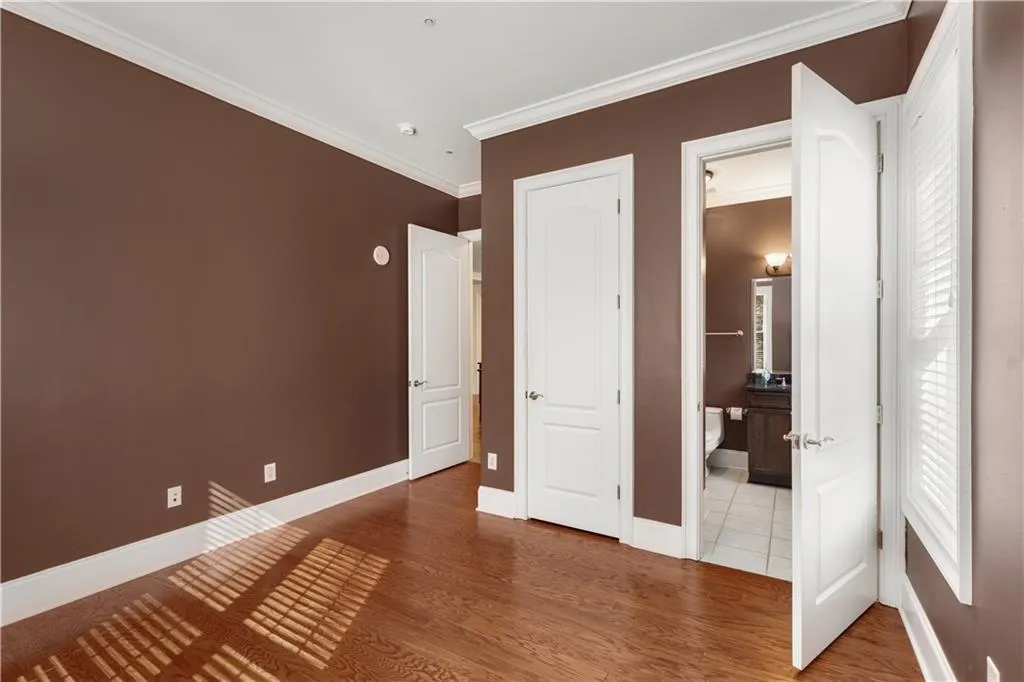 The door to the ensuite bathroom is open.  The closed door opens to the closet.