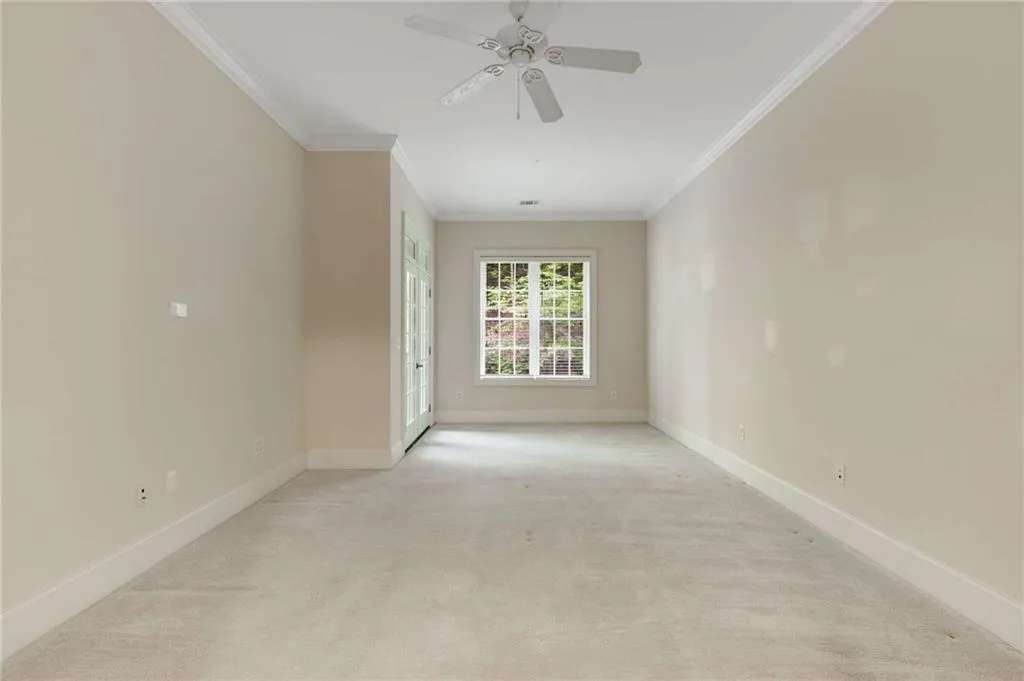 The Primary Bedroom has a large sitting area and glass French doors which open to the covered balcony.