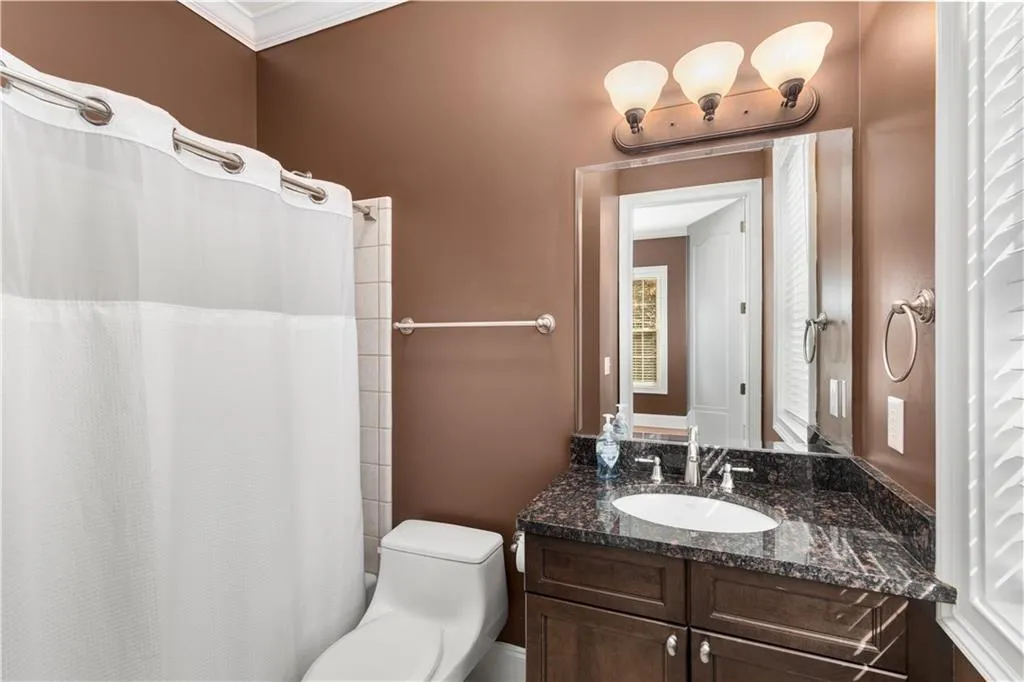 The bathroom has a window and tub /shower combination.